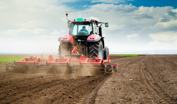 farmer in tractor preparing land for sowing