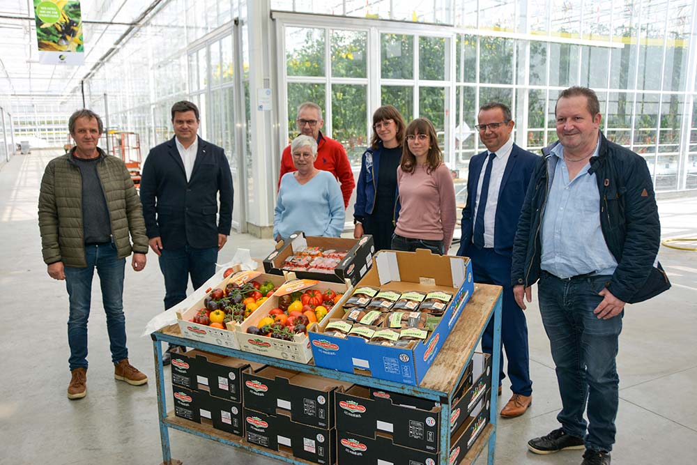 Un groupe de personnes devant un étal de légumes plus résistants à la sécheresse. - Illustration Observer les végétaux plus résilients