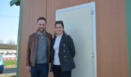 Un couple devant la porte d'un poulailler