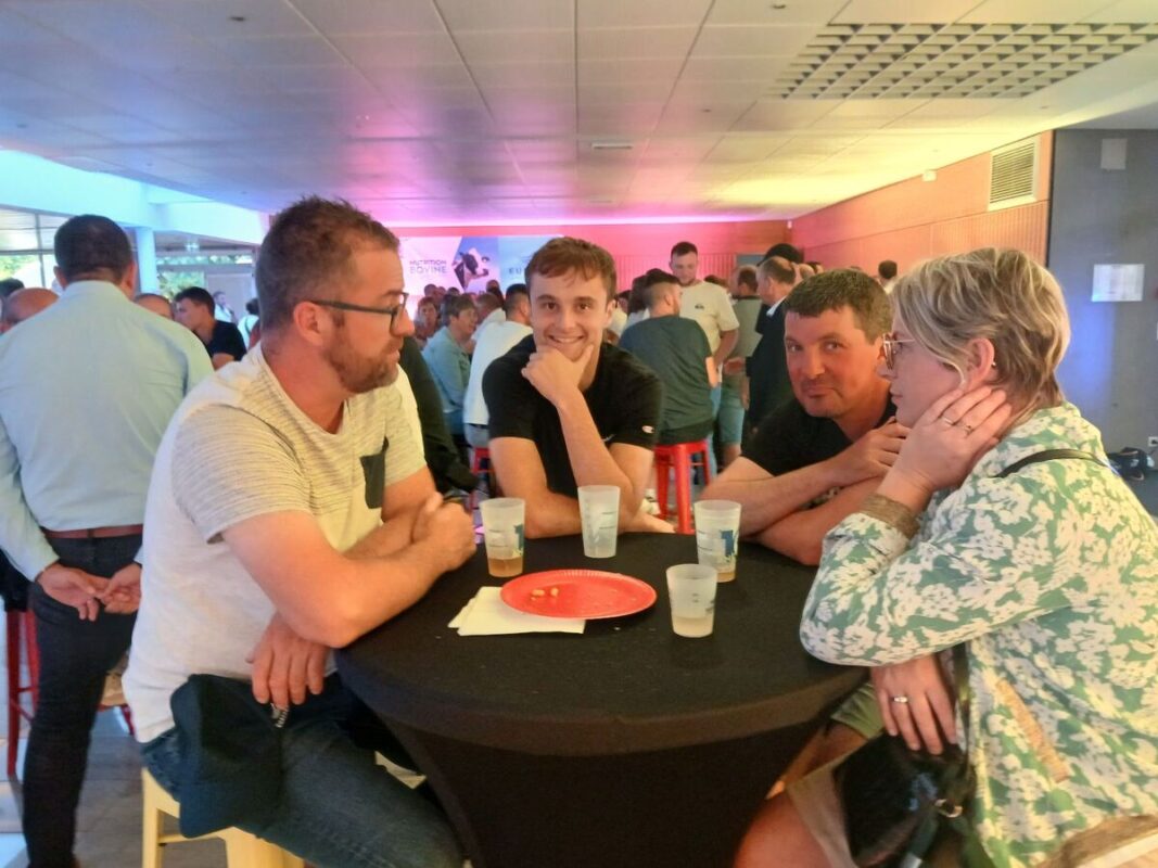 Des personnes accoudées à un mange debout lors d'un cocktail