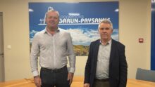 Deux hommes devant une affiche Garun-Paysanne