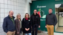 Trois hommes et deux femmesdevant une devanture